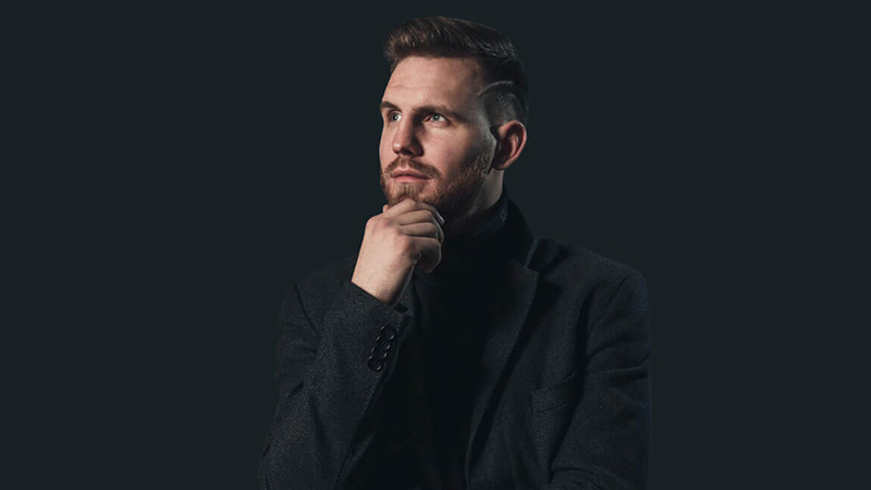 man-in-black-suit-jacket-full-width 1